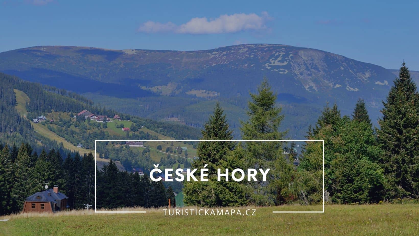 Ski areál U Čápa in Czech Republic - a field with trees and mountains in the background.
