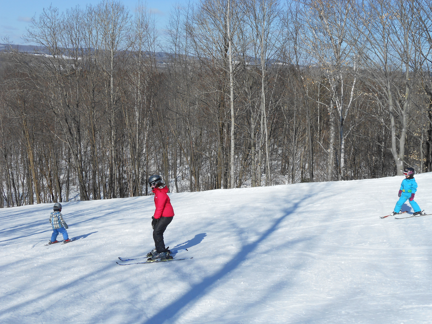 A winter sports scene at Parc de l'Île Melville showcasing a skier amidst a snowy landscape, subtly capturing the essence of a family skiing holiday in Mauricie, Quebec, Canada.