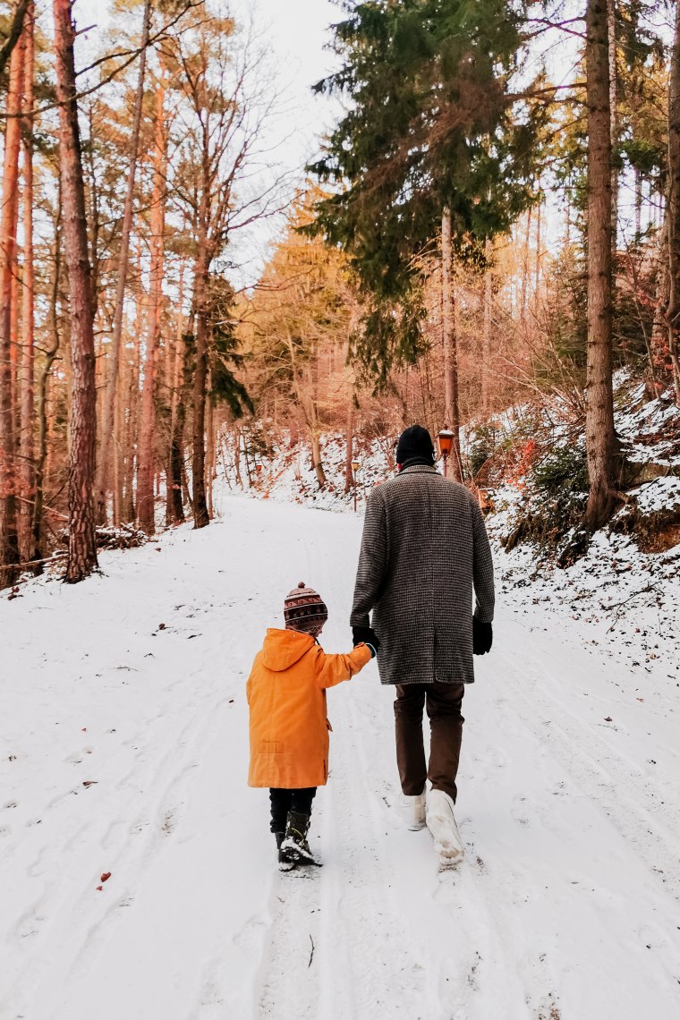Mönichkirchen | Mariensee in Austria - a father and son walking through the snow in the woods.