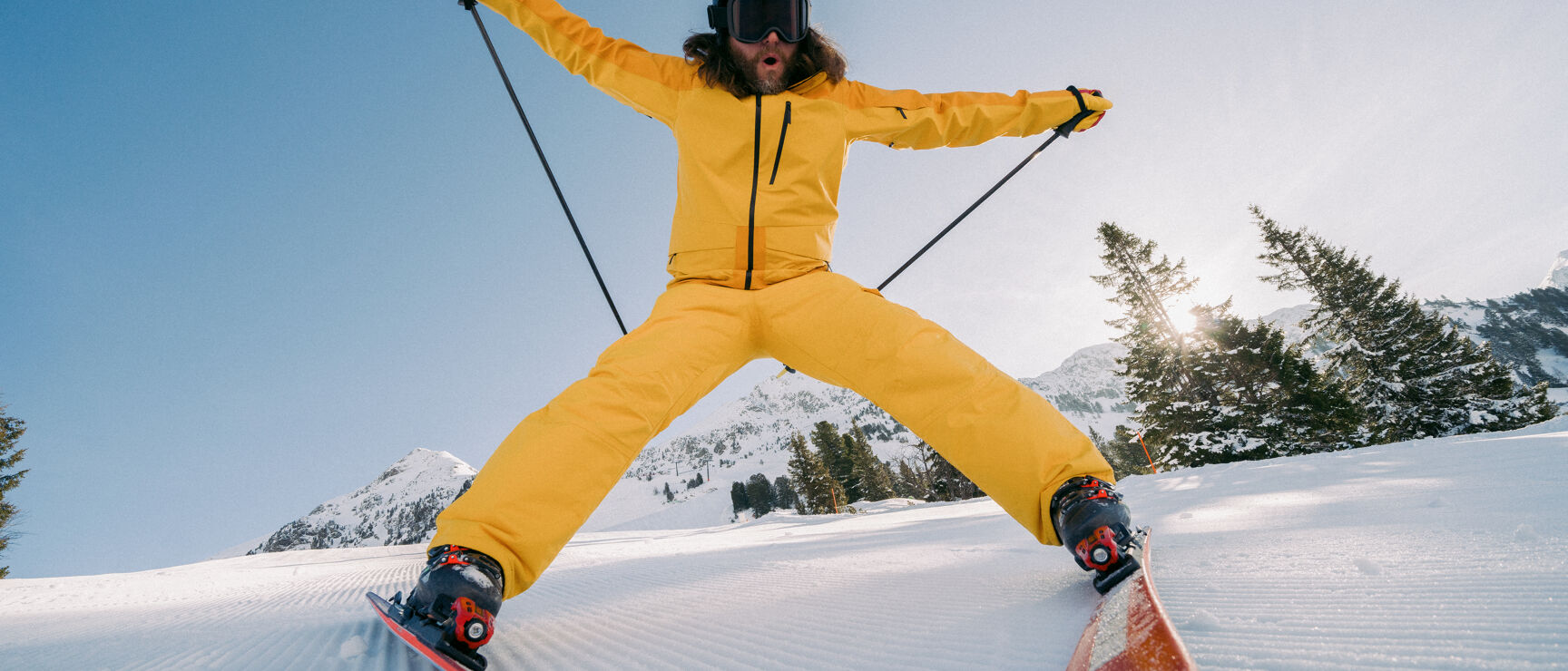 Mönichkirchen | Mariensee in Austria - a man in a yellow suit skiing down a hill.