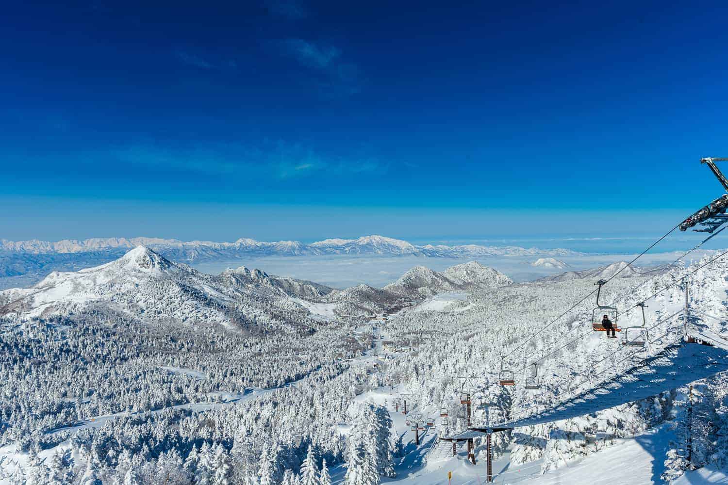 Shiga Kogen in Japan - a ski lift going up a snowy mountain.