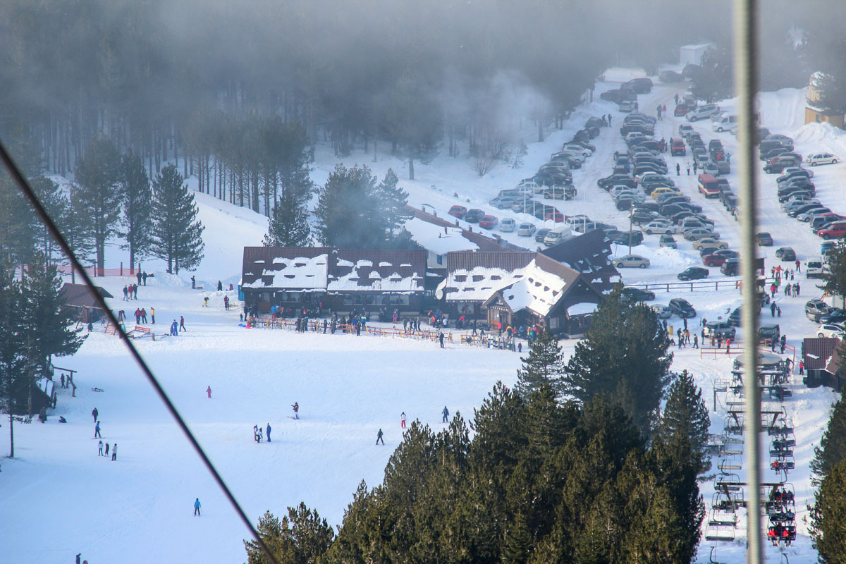 Pridolci in Bosnia and Herzegovina - a group of people skiing down a snowy hill.