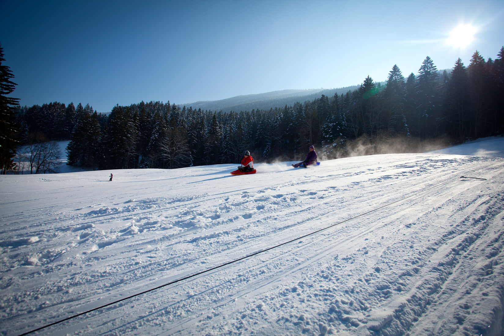 Les Verrières in Switzerland - a person riding a snowboard down a snowy slope.
