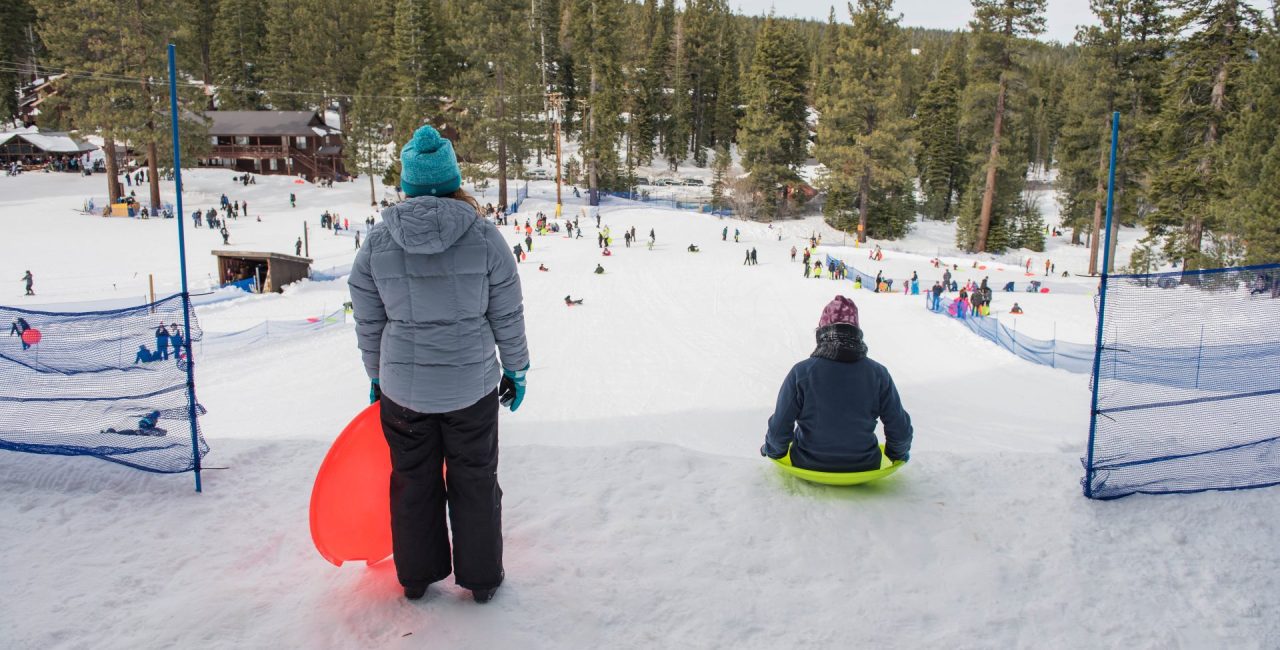 Granlibakken in USA - two people on snowboards in the woods.