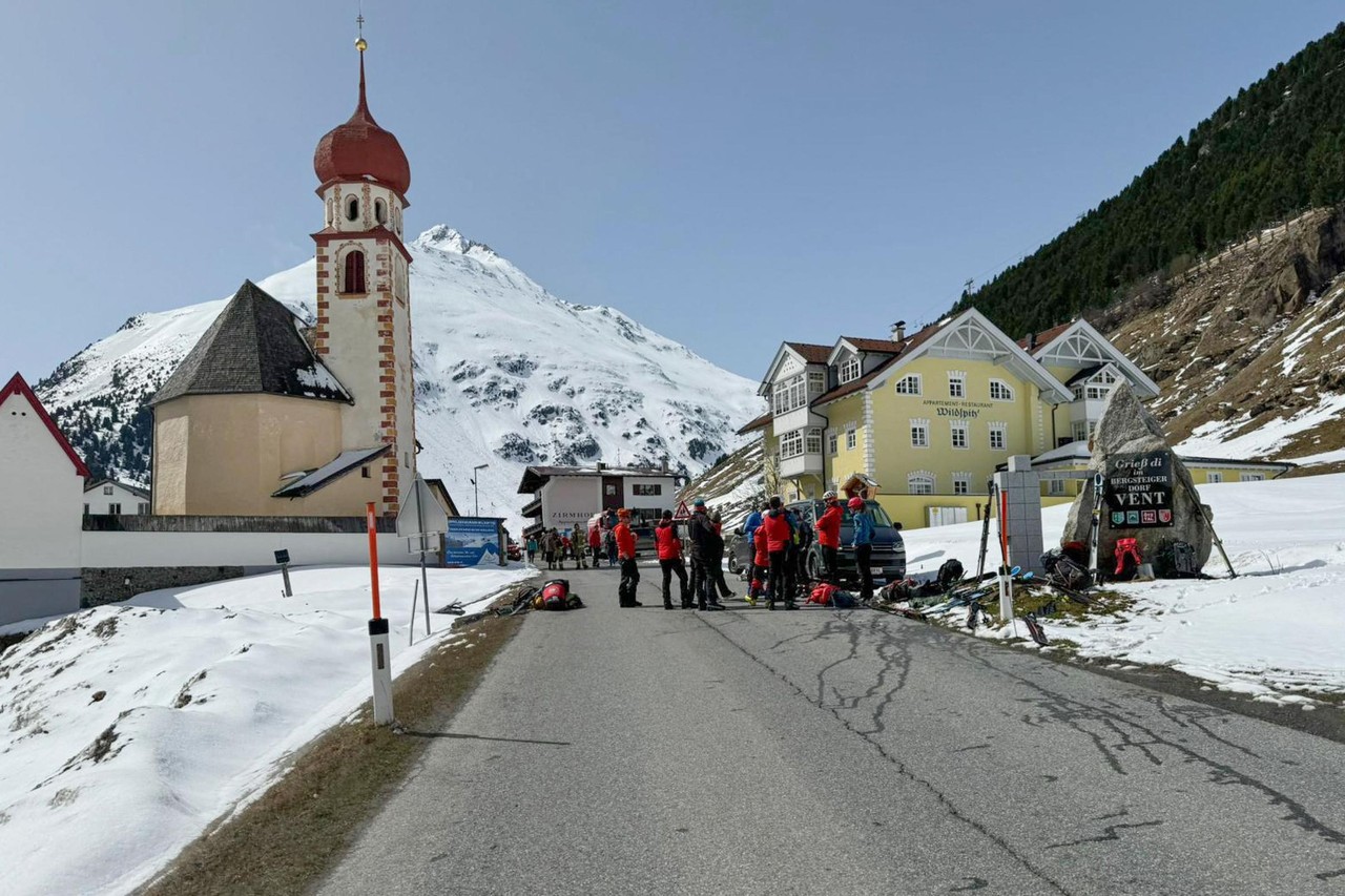 Vent in Austria - a group of people standing on the side of a road.