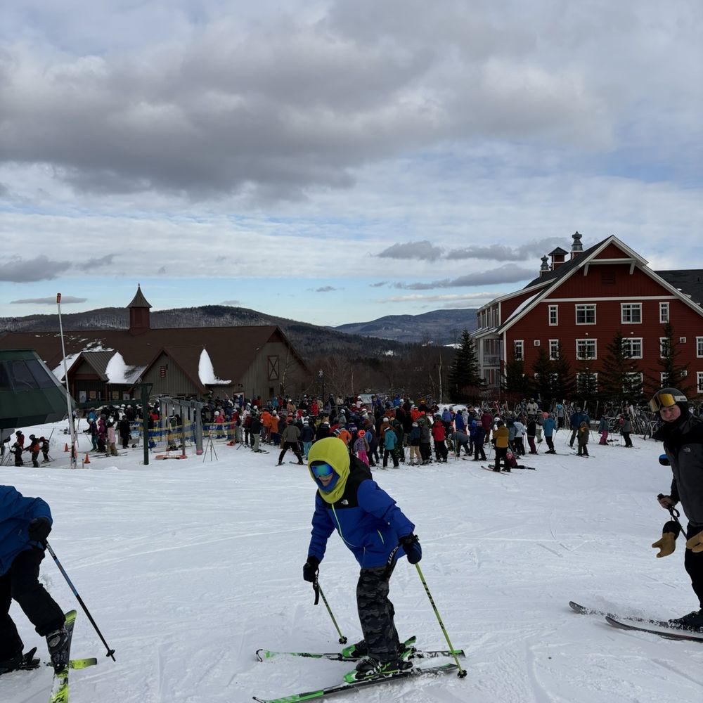 Beartown in USA - a group of people skiing down a hill.