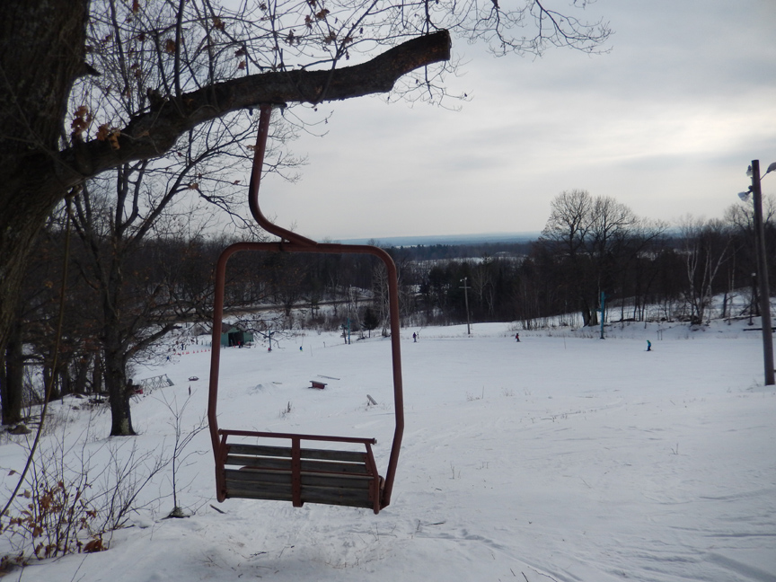 Winter sports scene at Beartown in The Adirondacks, New York, featuring a chalet, a ski lift, and a picturesque snowy landscape at a winter sports centre.