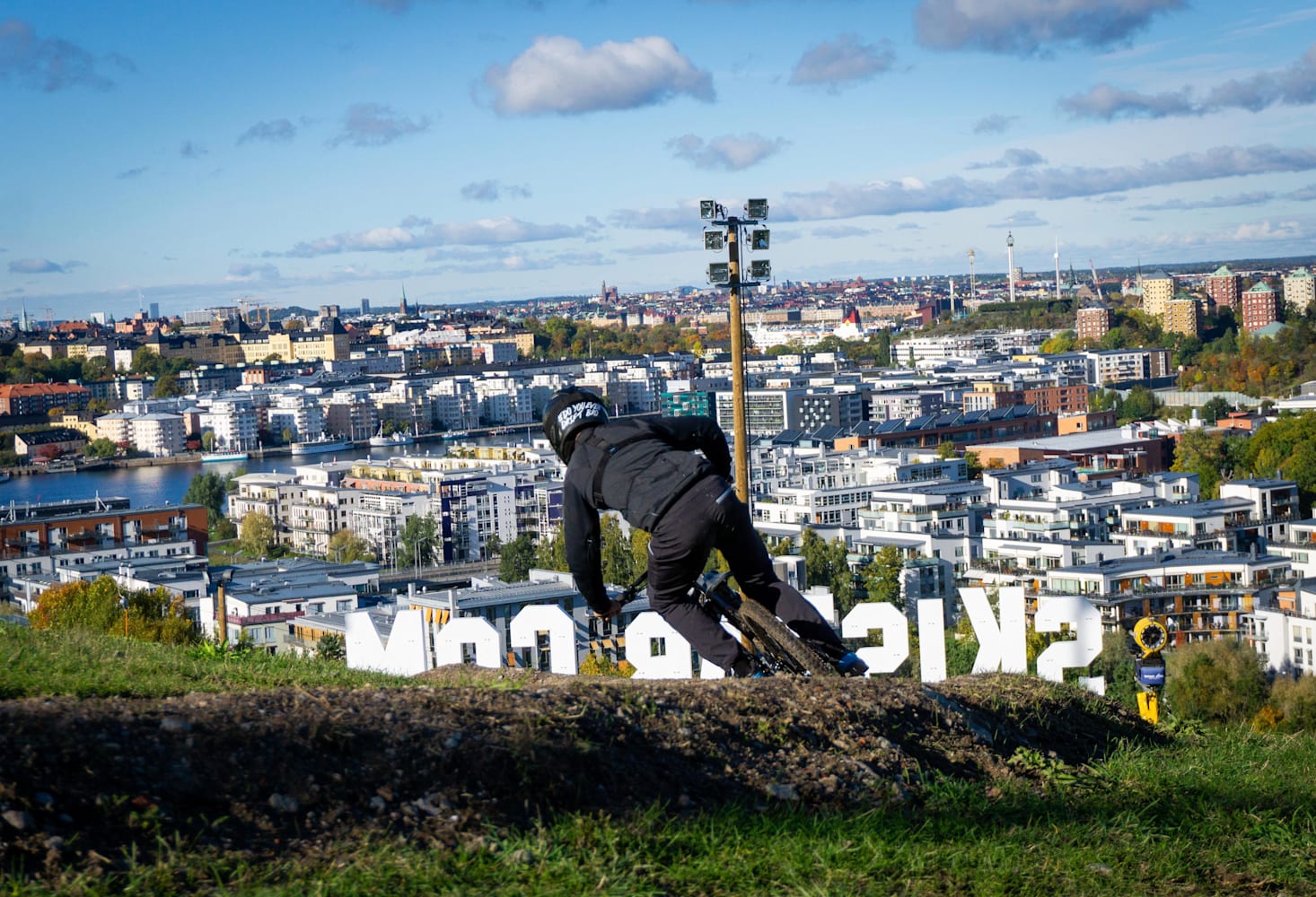 Skönviksbacken in Sweden - a man working on a hill overlooking the city of reykjavik.