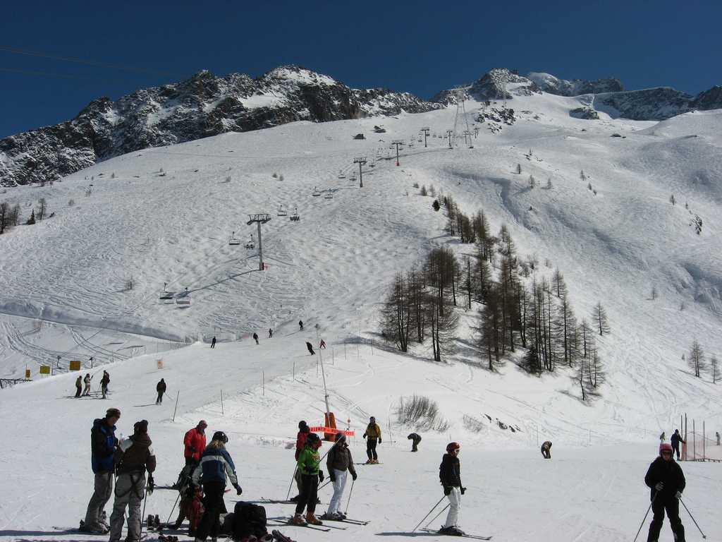 Grands Montets – Argentière in France - a group of people skiing down a snowy slope.