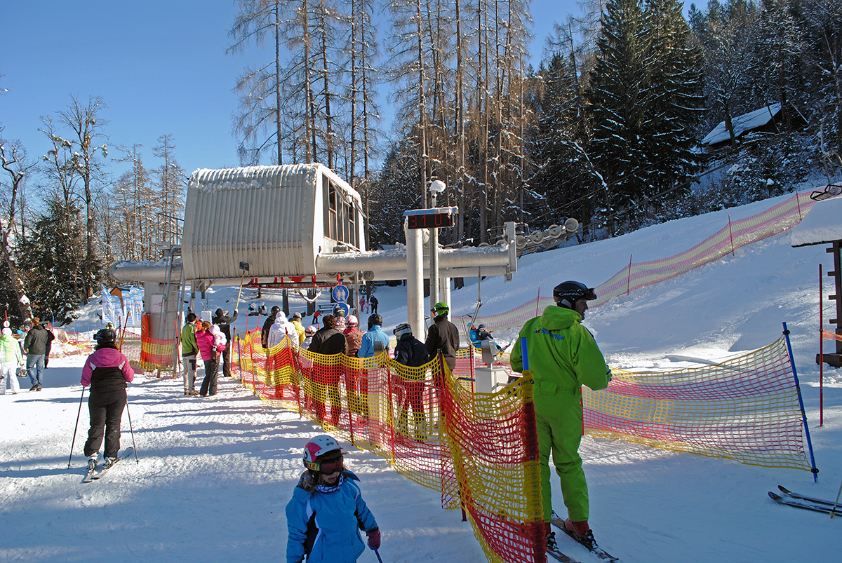 Dole Pri Litiji in Slovenia - a group of people skiing down a snowy hill.