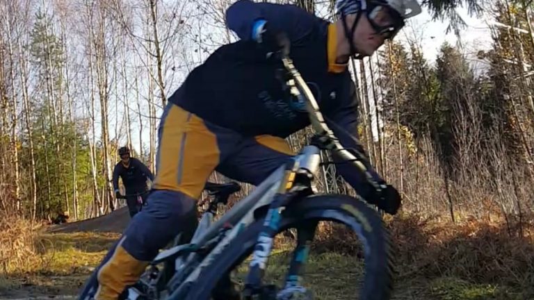 Hanaslöv in Sweden - a man riding a bike down a dirt road.