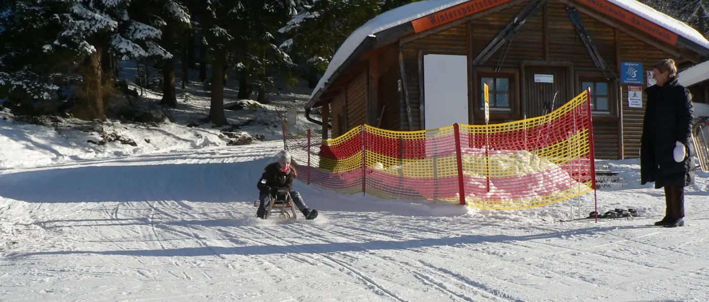 Brotjacklriegel – Langfurth in Germany - a man and a dog are standing in the snow.
