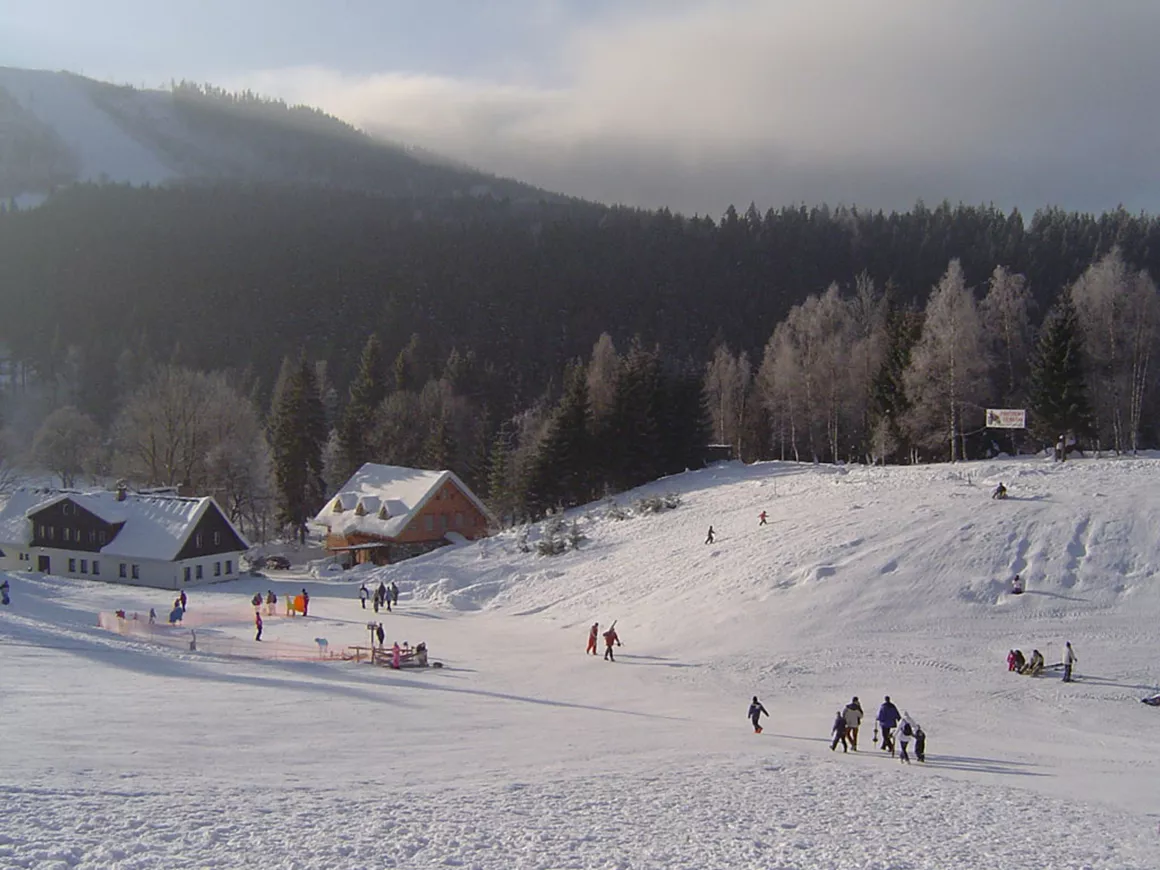 Luisino Údolí in Czech Republic - a group of people skiing down a hill.