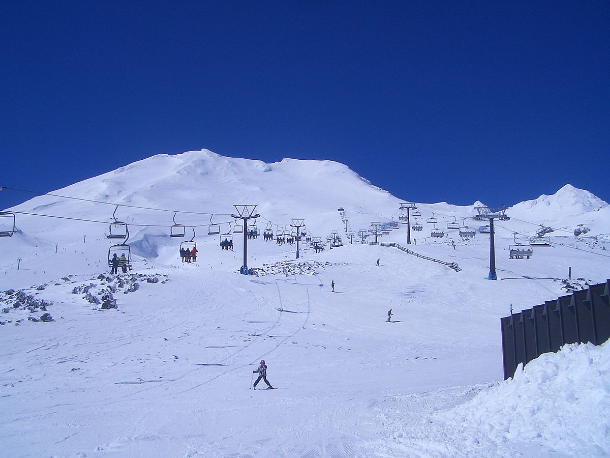 Turoa Mt Ruapehu in New Zealand - a group of people skiing down a snowy hill.