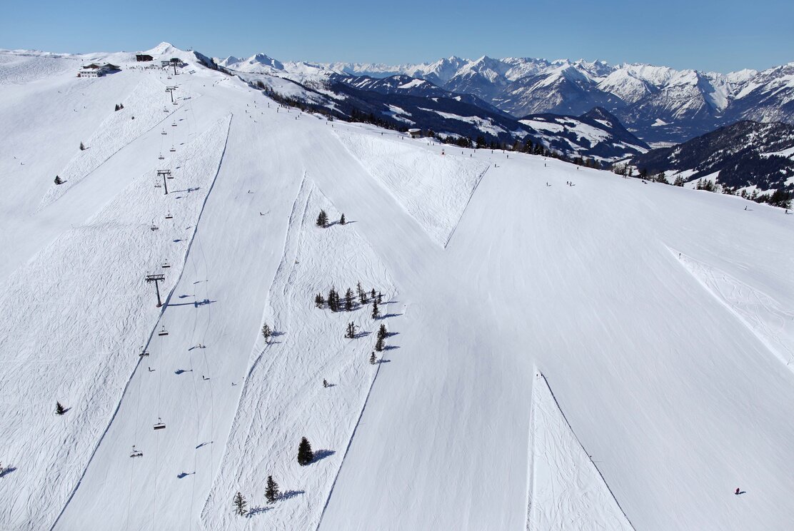 Juwel Alpbachtal Wildschönau in Austria - a ski slope with lots of snow on it.