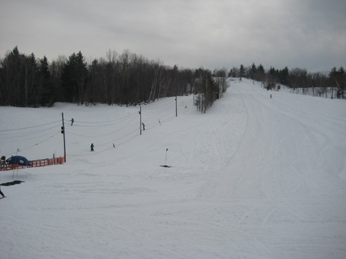 A winter sports scene at Veterans Memorial in Franklin New Hampshire featuring a ski resort ski lift a skier in action amidst the captivating beauty of a winter sports centre.