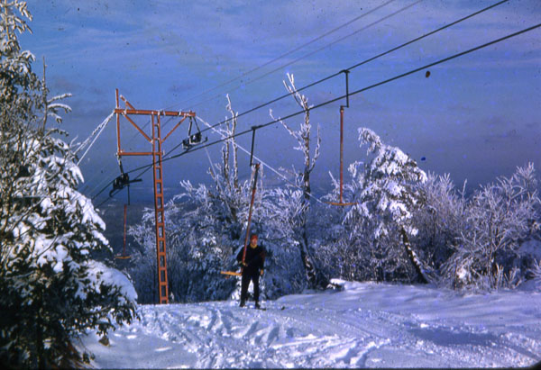 Ski lift rising above a snow-covered landscape at Veterans Memorial - Franklin, New Hampshire. Stunning winter scenery frames the bustling ski resort.
