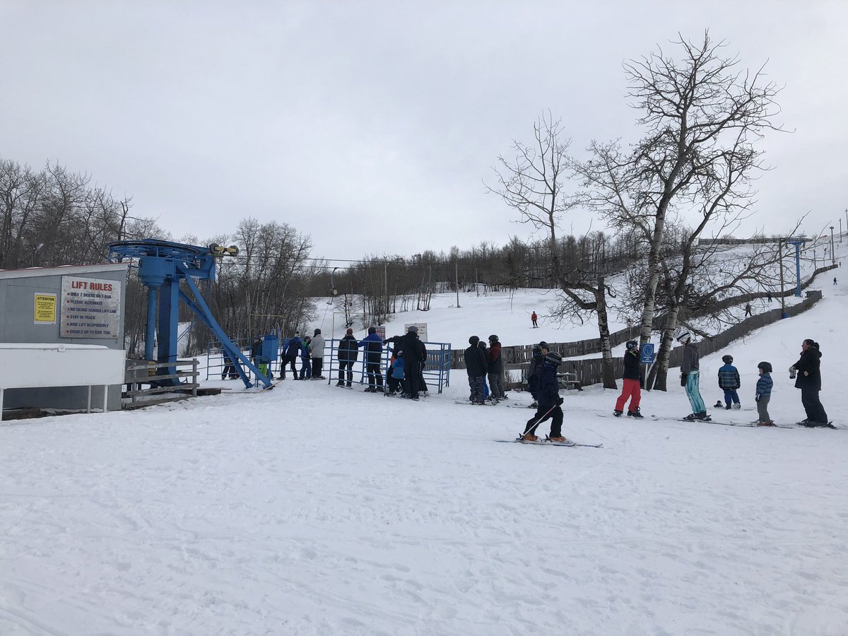 Gwynne Valley in Canada - a group of people standing on top of a snow covered slope.