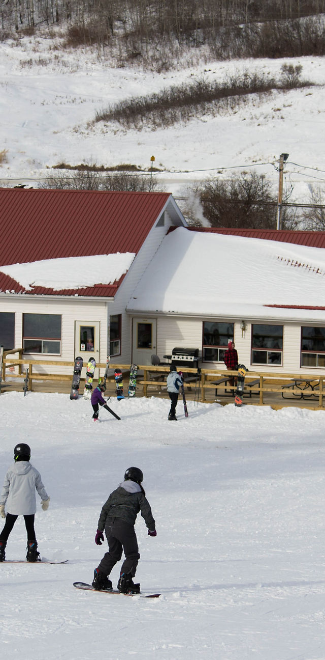 Gwynne Valley in Canada - a group of people riding snowboards on a snowy slope.
