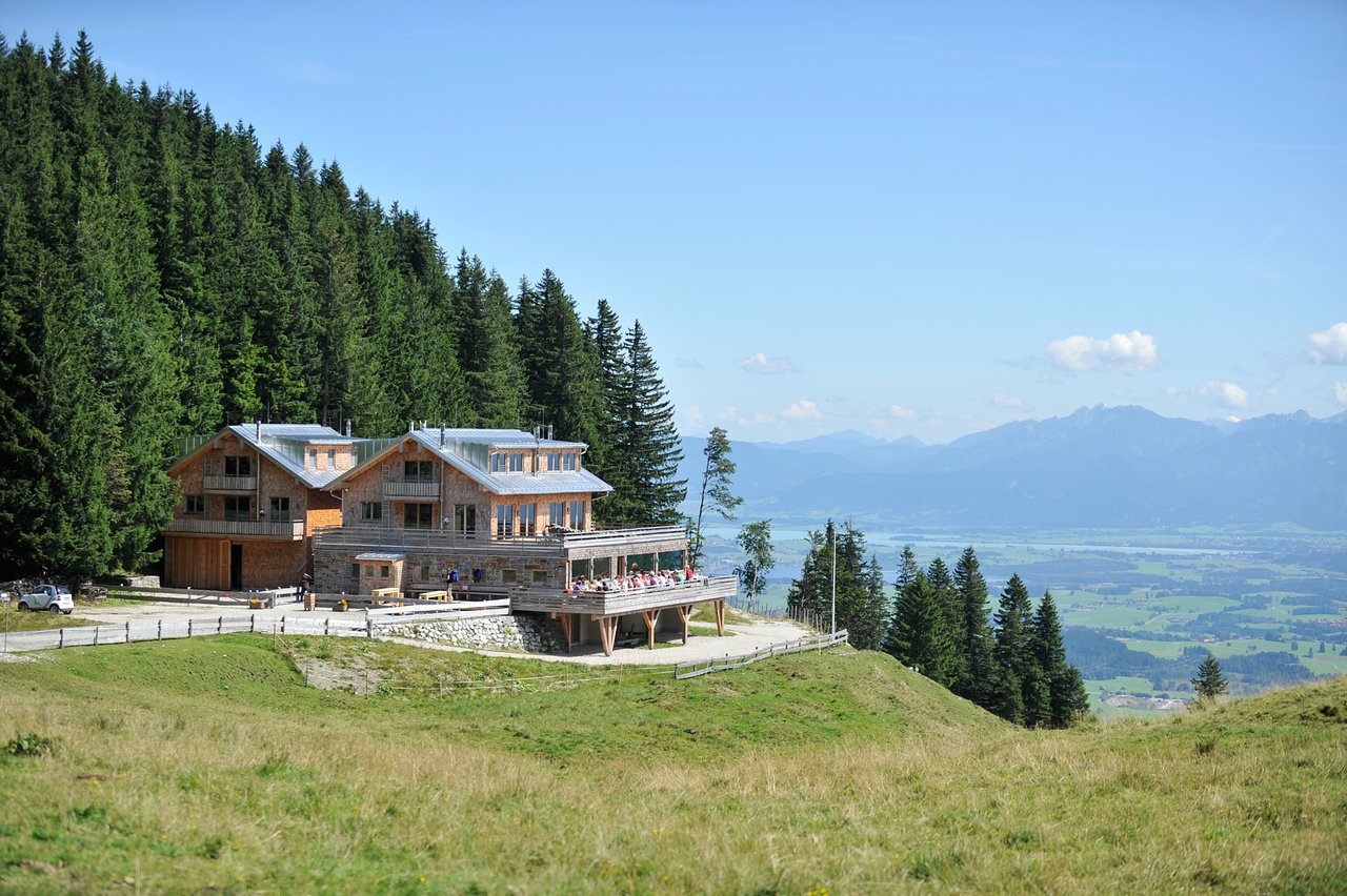 Nesselwang – Alpspitze in Germany - a house on top of a hill in the swiss alps.