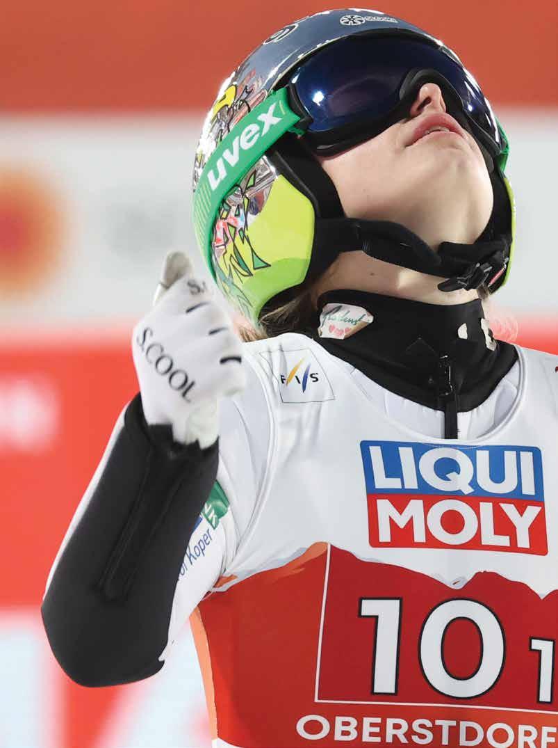 Druni KidsArena – Valtgeva in Switzerland - a woman in ski gear holding her ski poles.