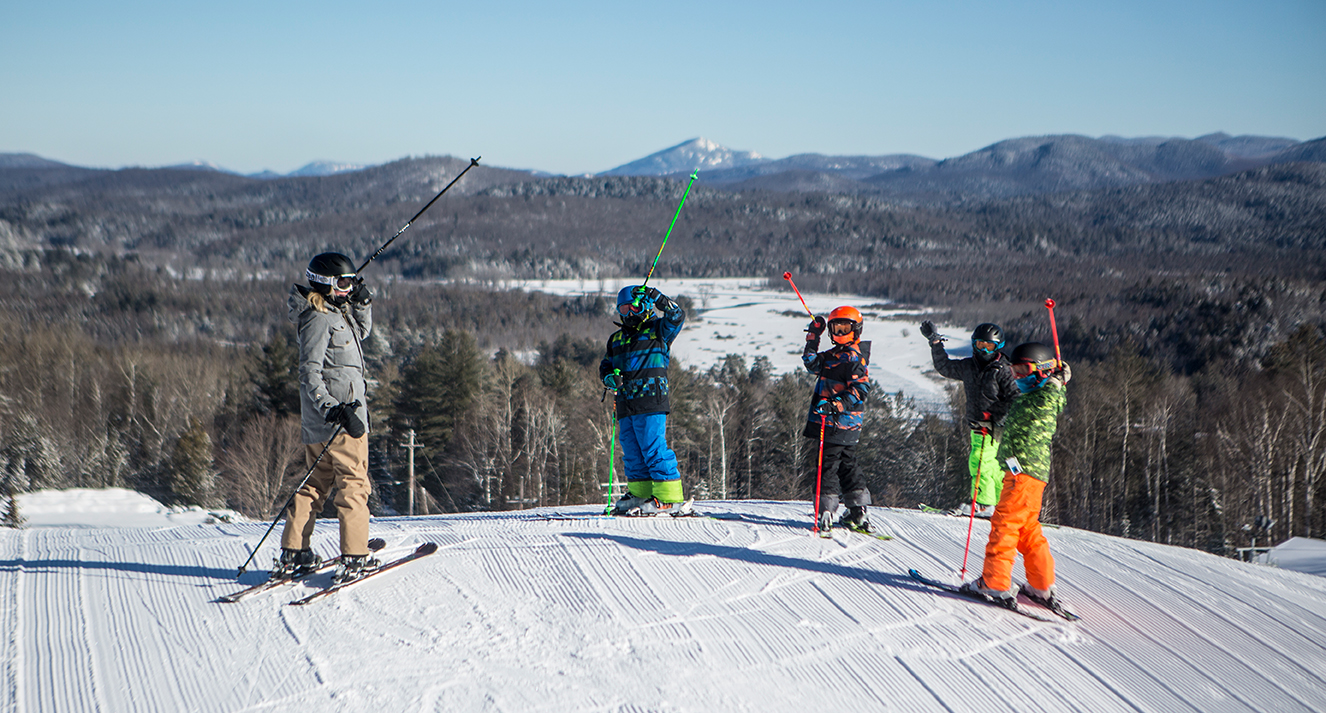 Mt Pisgah in USA - a group of people standing on top of a snow covered slope.