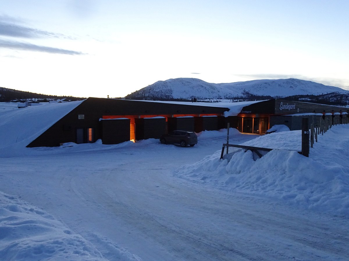 Fjellsyn in Norway: a snow covered road next to a building.