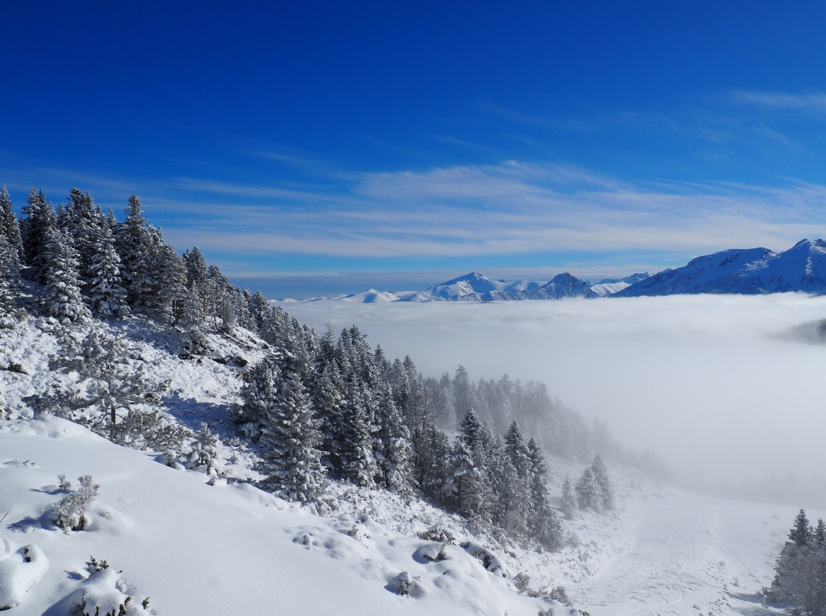 Ax 3 Domaines – Ax-les-Thermes in France - a view from the top of a snowy mountain.
