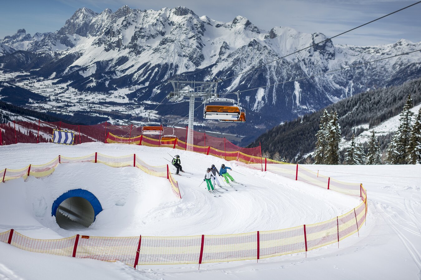 Bacherleitn – Weißenbach bei Liezen in Austria - two people skiing down a slope in the mountains.