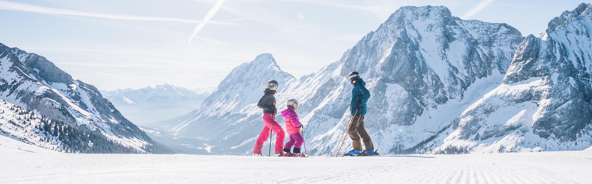 Karlift – Heiterwang in Austria - two people standing on top of a snow covered mountain.