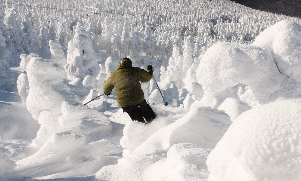 Sugarloaf Mountain in USA - a person skiing down a hill covered in snow.