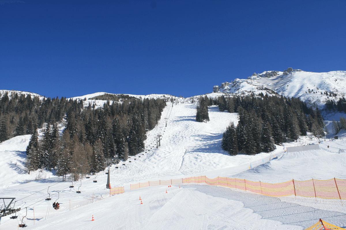 Axamer Lizum in Austria - a view of a ski slope with trees in the background.