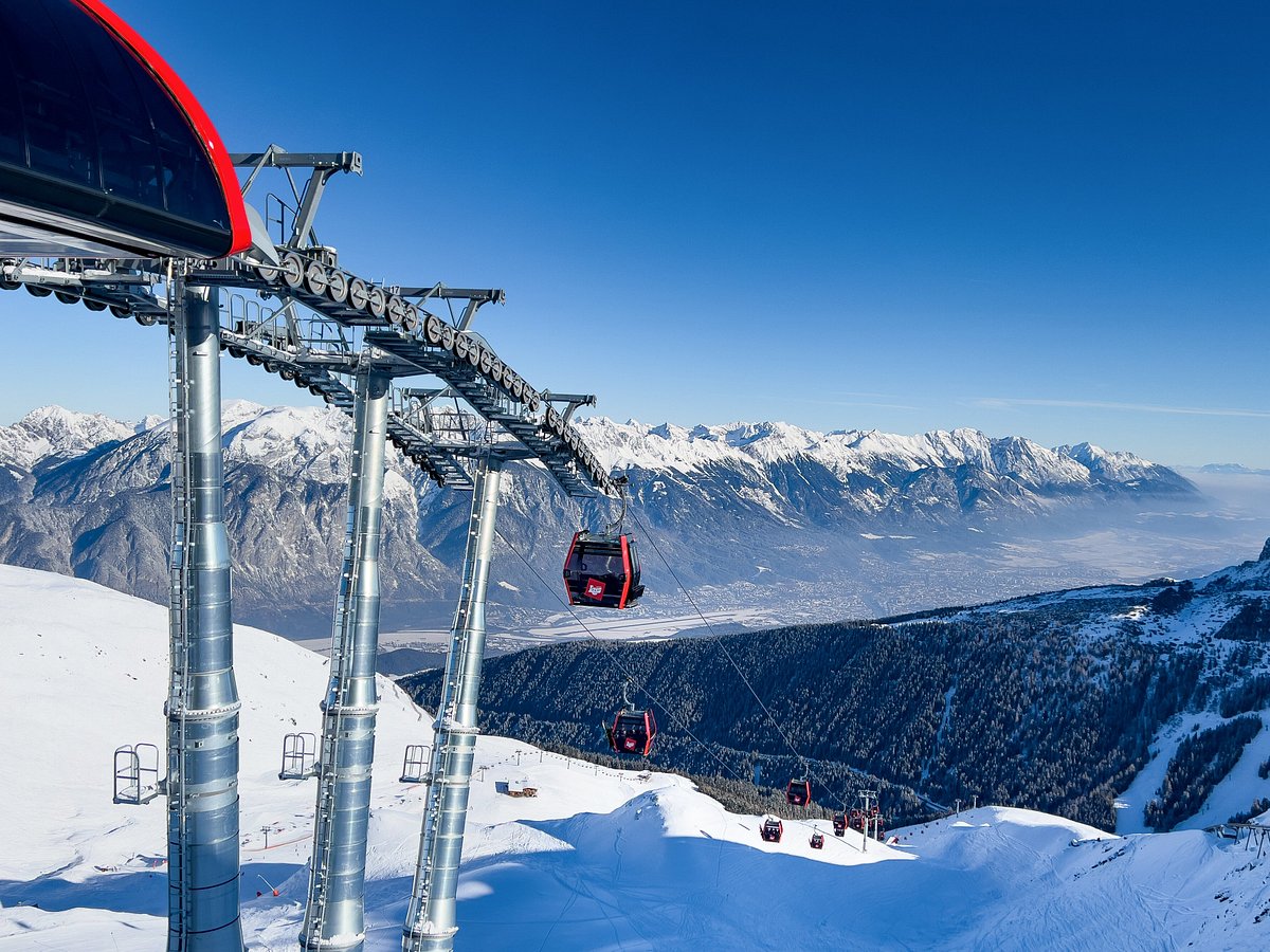 Axamer Lizum in Austria - a ski lift going up a snowy mountain.