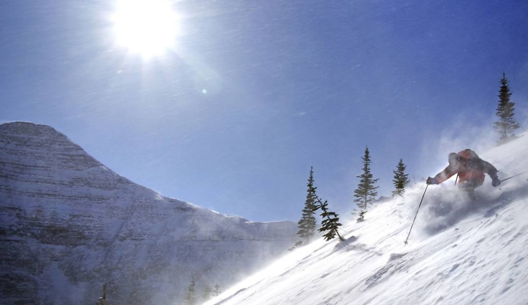 A skier in action at Little Ski Hill in Idaho amidst a quintessential winter sports scene. The snow-covered slopes of the ski resort subtly underlines the thrill of winter sports.
