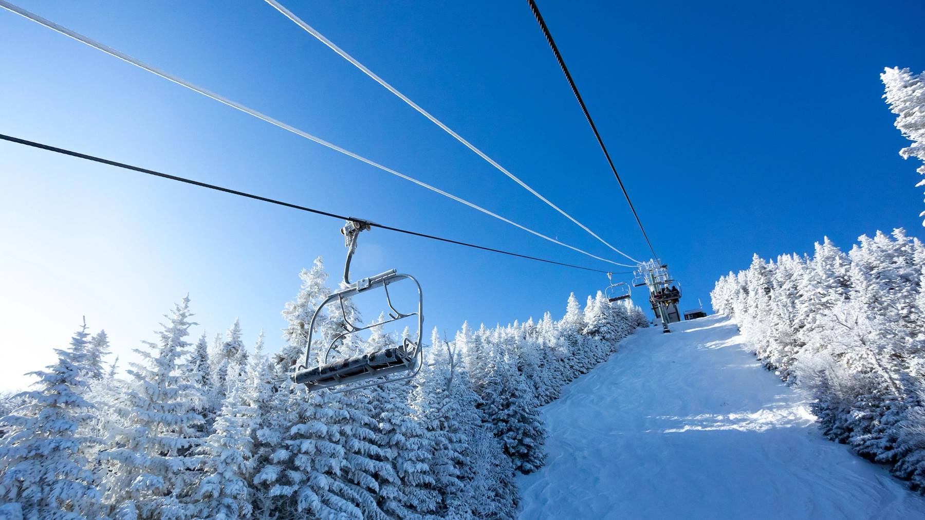 Sugarbush Resort in USA - a ski lift going up a snowy slope.