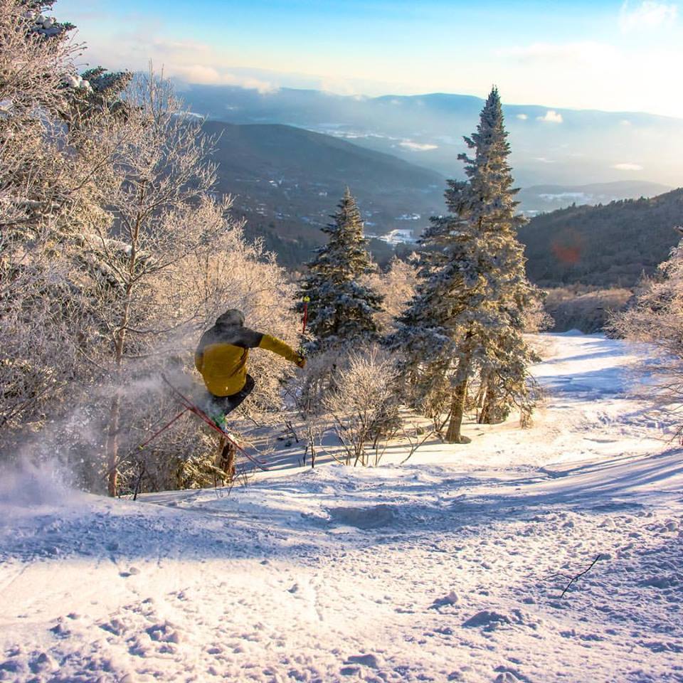Sugarbush Resort in USA - a person riding a snowboard down a snowy slope.