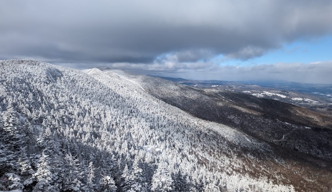 Sugarbush Resort in USA - a view from the top of a snowy mountain.