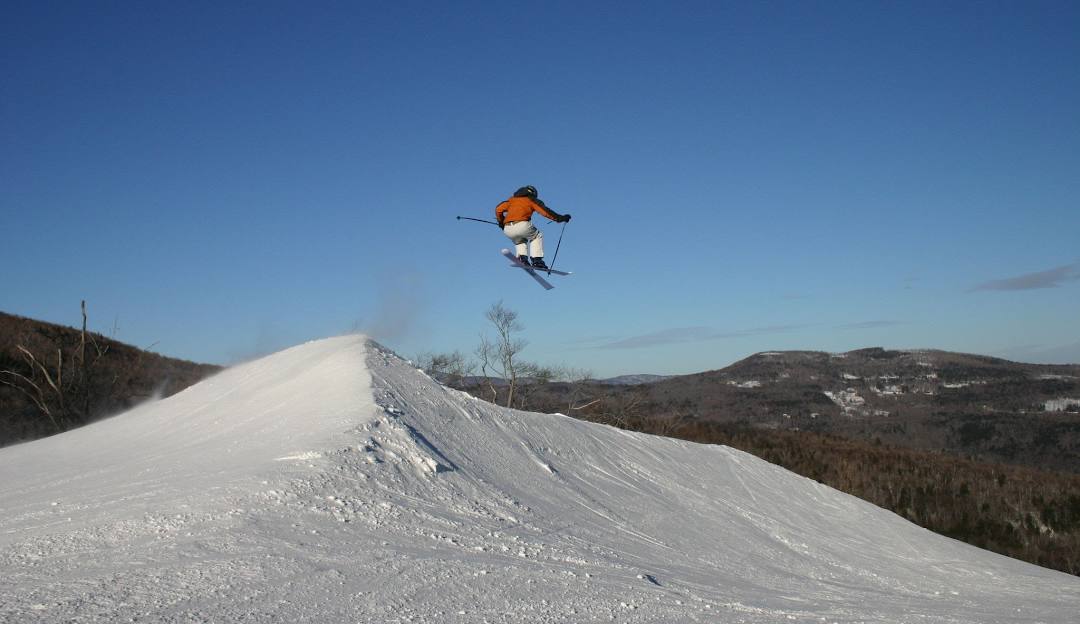 Sugarbush Resort in USA - a snowboarder doing a trick on a slope.