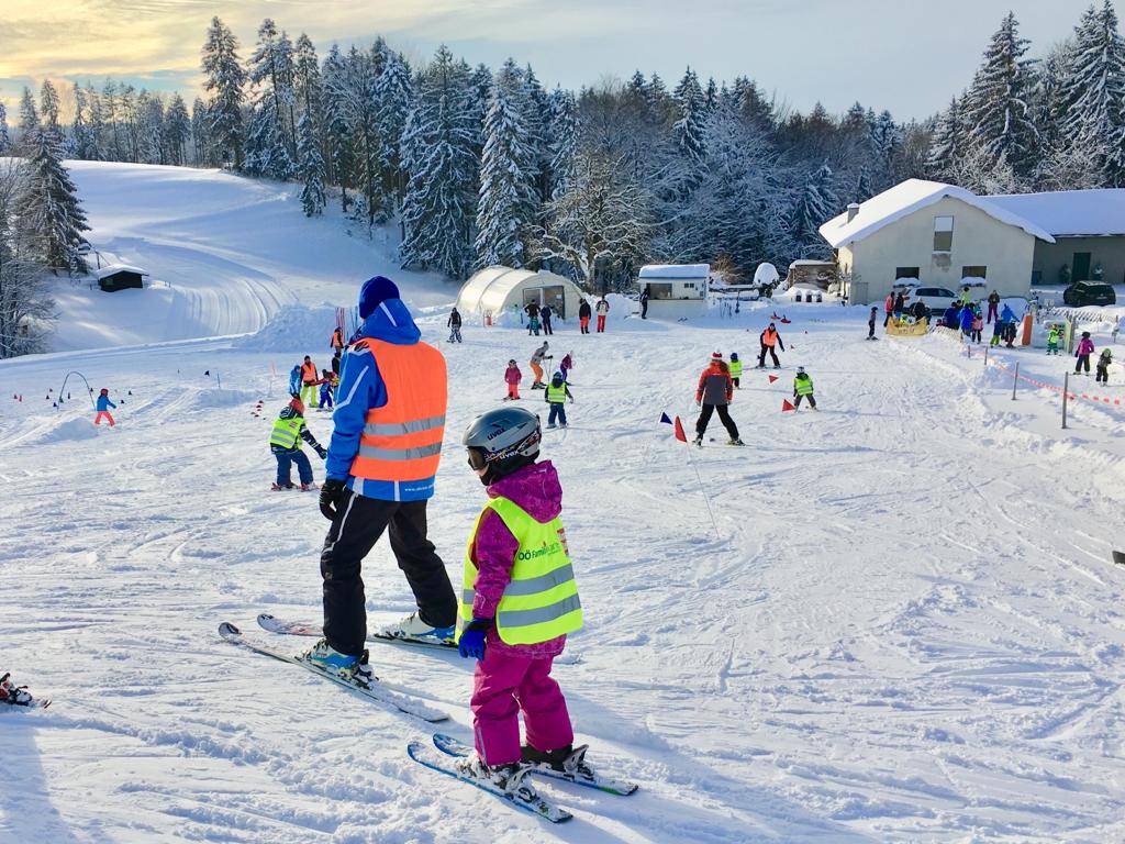 Kronberg – Attergau in Austria - a group of people skiing down a snowy slope.
