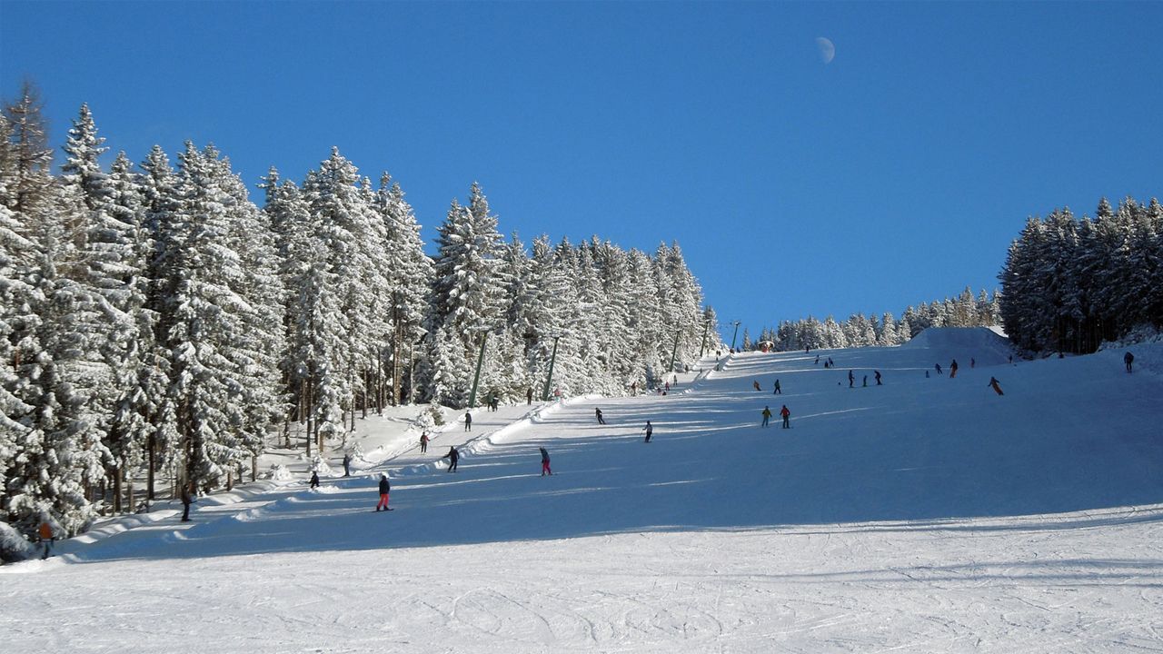Hüttegglift – Weerberg in Austria - a group of people skiing down a snowy slope.