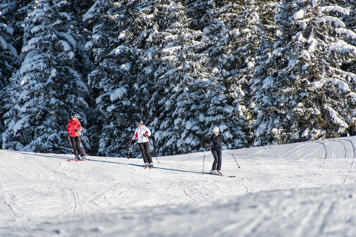 Hüttegglift – Weerberg in Austria - a group of people skiing down a snowy slope.