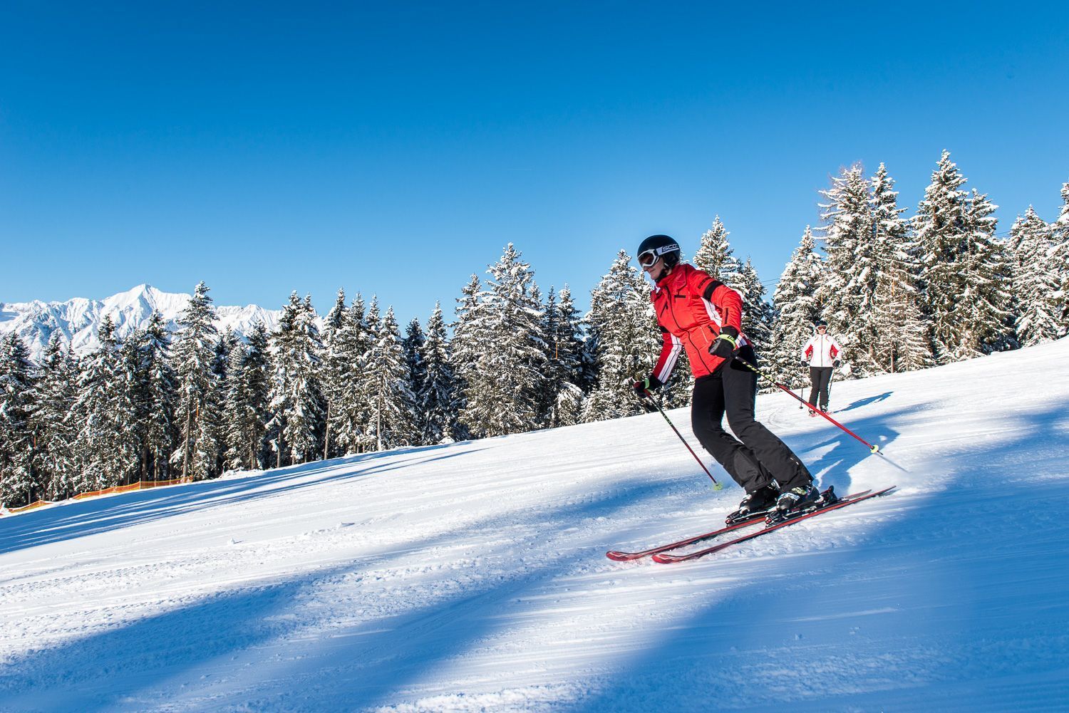 Hüttegglift – Weerberg in Austria - a man in red jacket skiing down a hill.