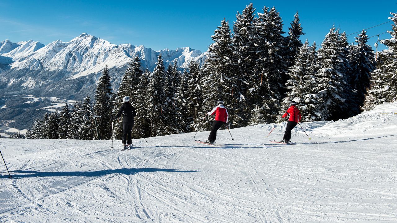 Hüttegglift – Weerberg in Austria - a group of people skiing down a snowy slope.
