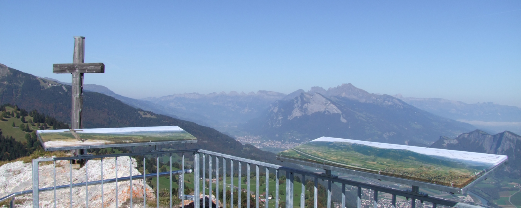 Tristeli – St Margrethenberg in Switzerland - a cross on top of a mountain with mountains in the background.