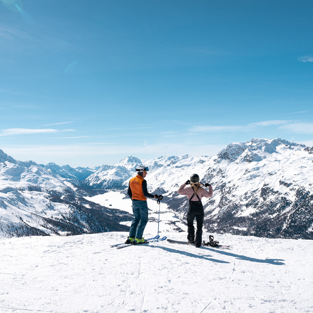 Müsella – La Punt in Switzerland - a couple of people standing on top of a mountain.
