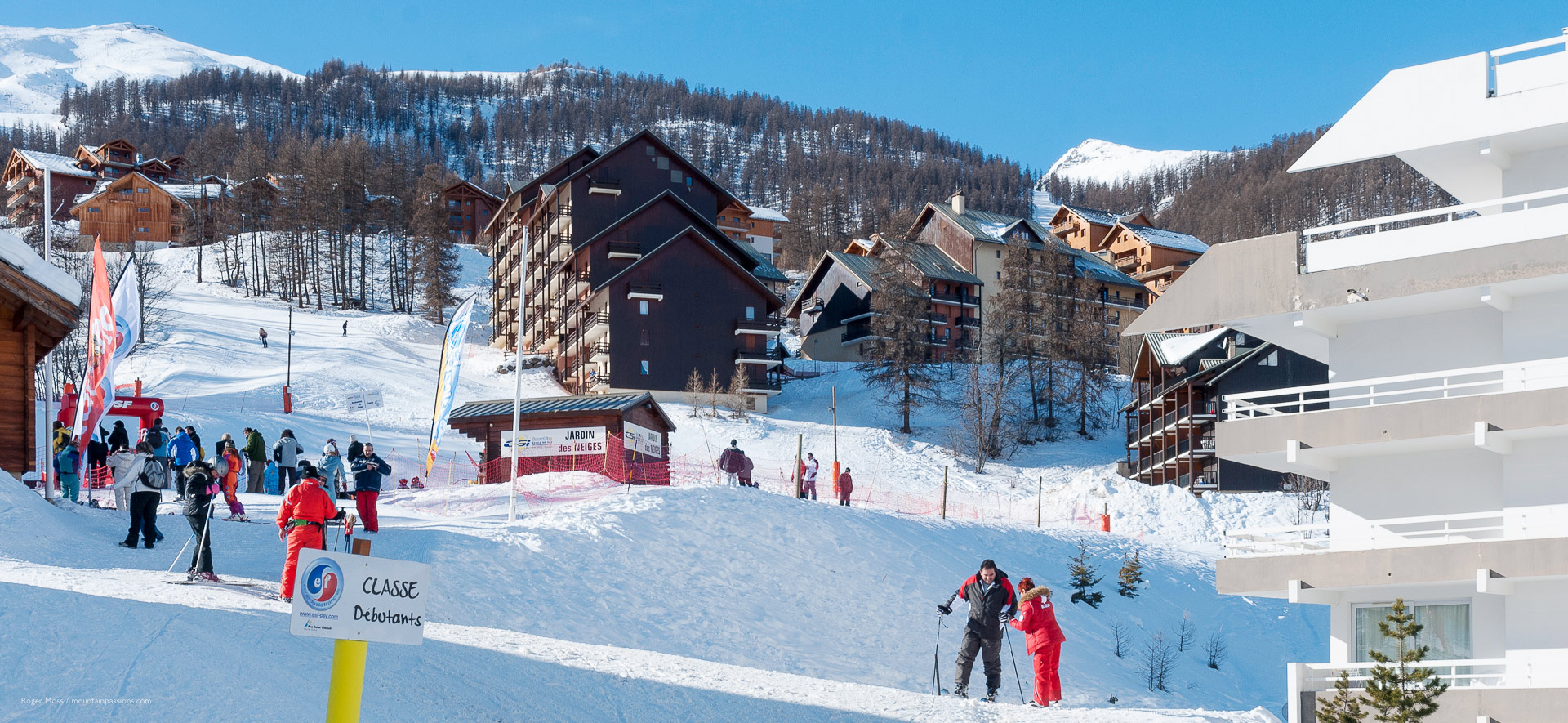 Puy Saint Vincent in France - a group of people skiing down a snowy hill.