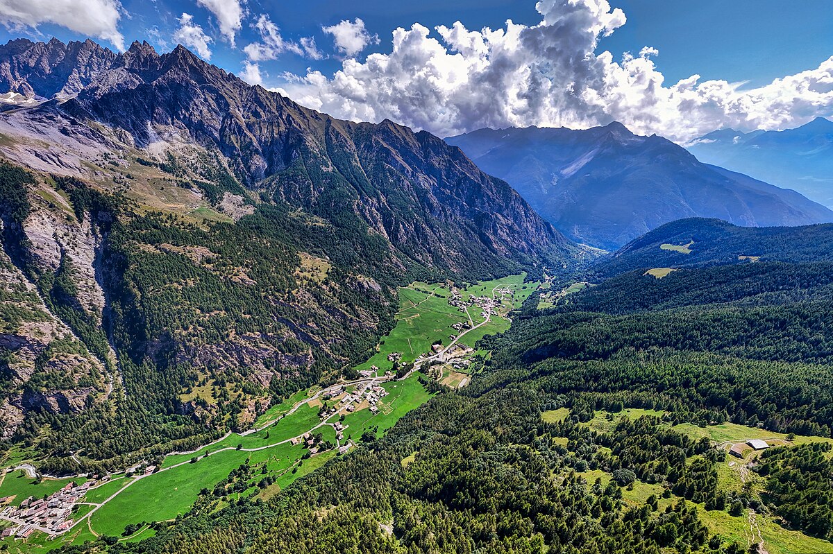 Ollomont in Italy - a view of the valley and mountains from the top of a mountain.