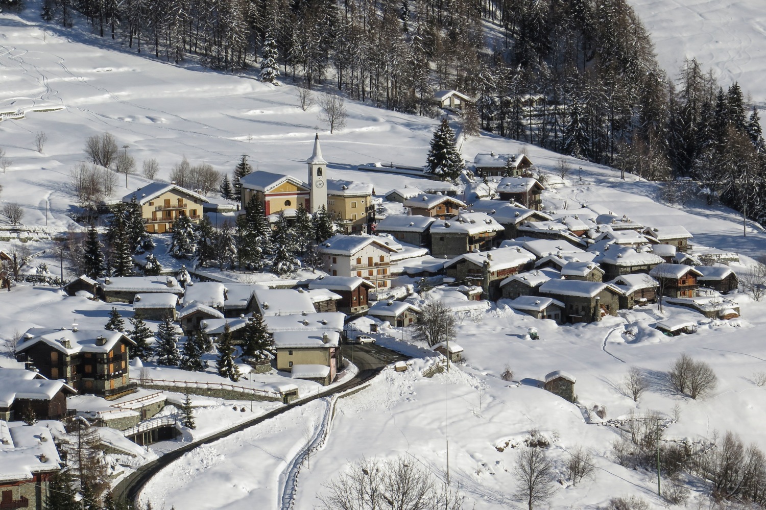 Ollomont in Italy - a small village in the mountains covered in snow.