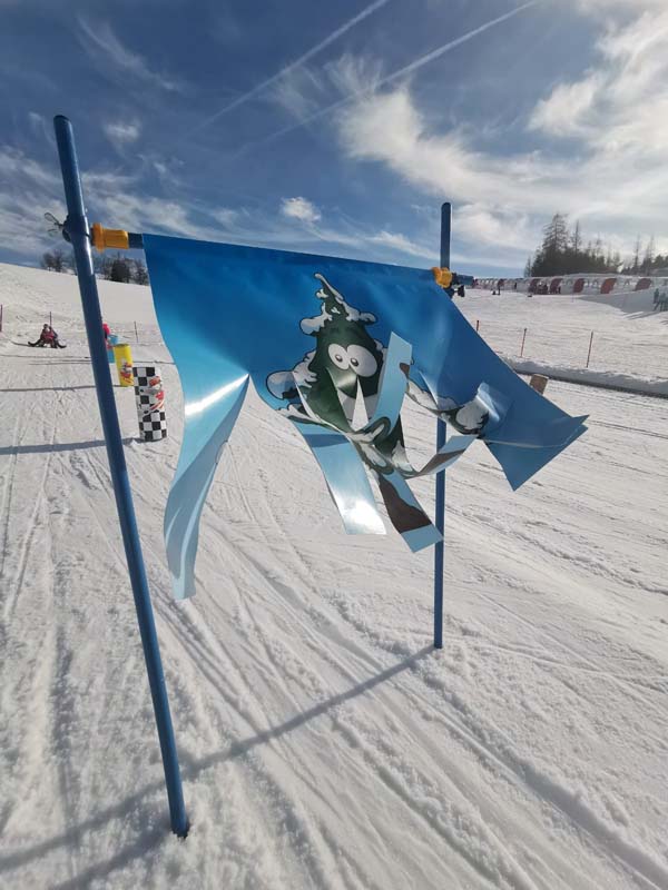 Birkenlift in Austria - a blue flag on top of a snowy slope.