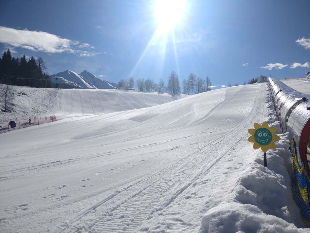 Birkenlift in Austria - a train traveling down a snow covered slope.